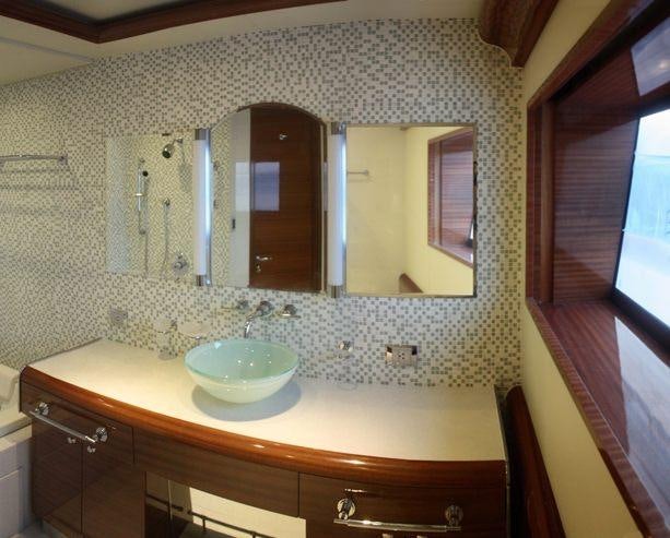 a bathroom with a sink and a mirror aboard ATLANTIS II Yacht for Charter
