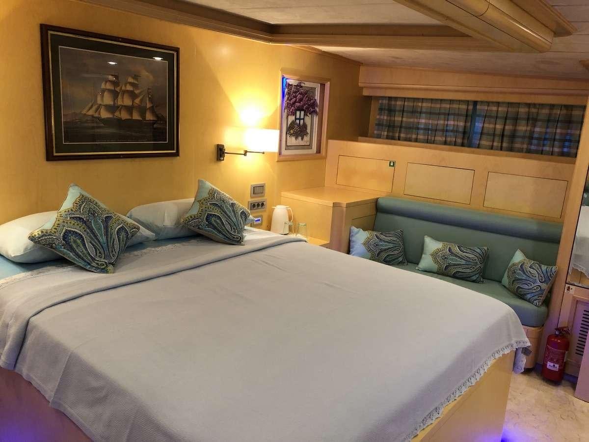 a bed with pillows on it aboard RIGEL Yacht for Charter