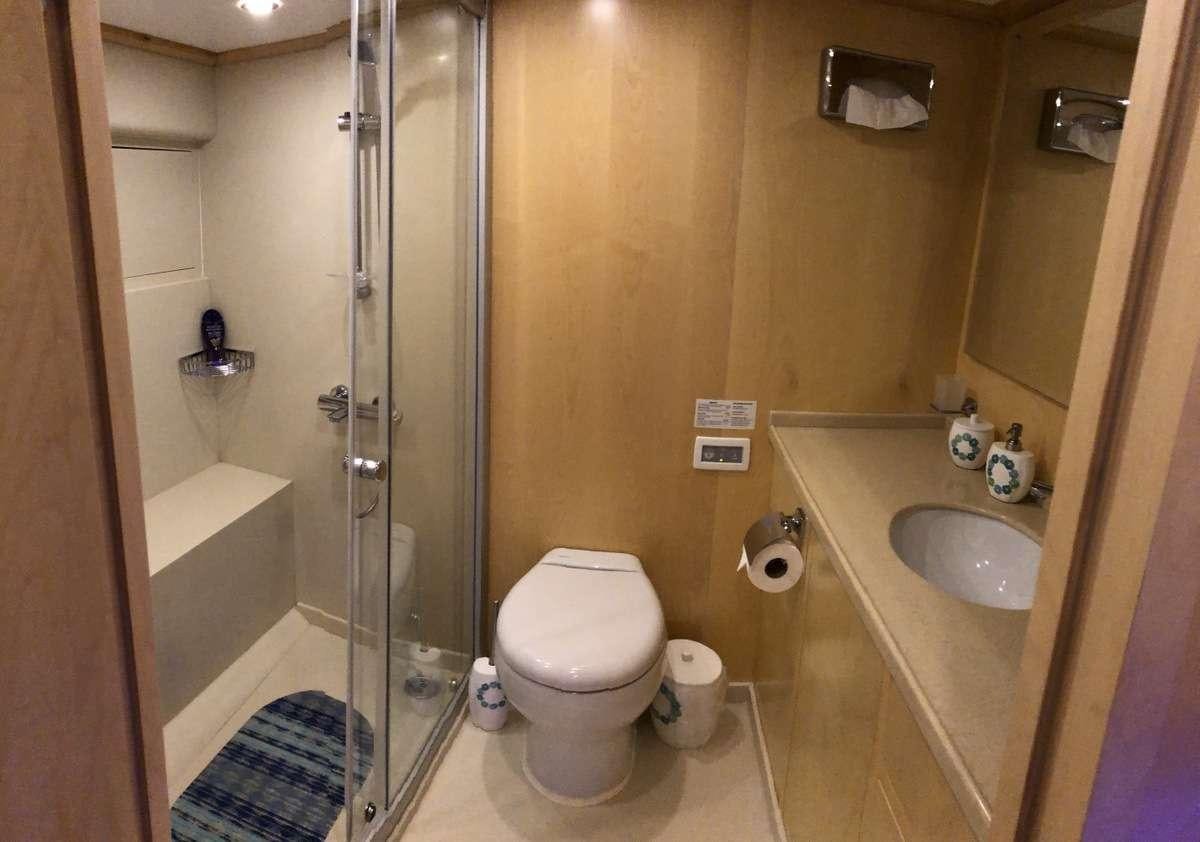 a bathroom with a glass shower aboard RIGEL Yacht for Charter