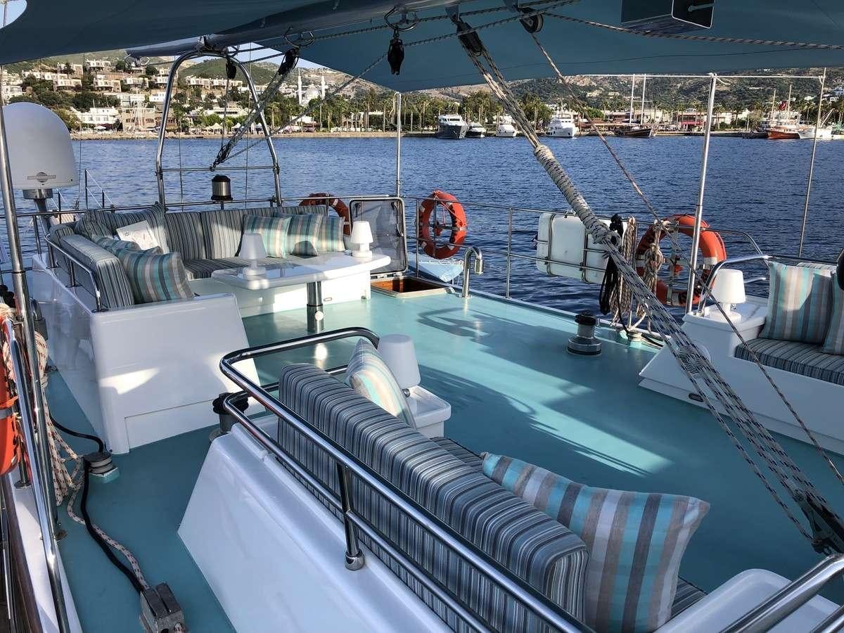 a boat with a deck and chairs aboard RIGEL Yacht for Charter