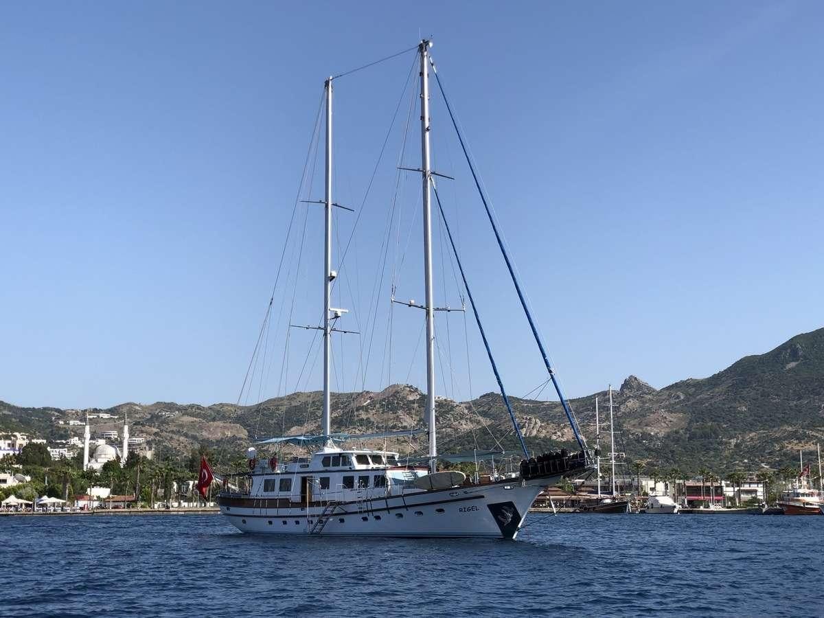 a boat sailing on the water aboard RIGEL Yacht for Charter