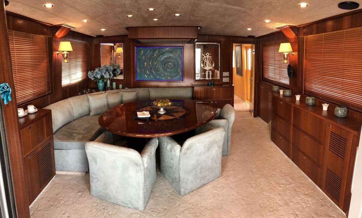 a living room with a couch and a table aboard RIGEL Yacht for Charter