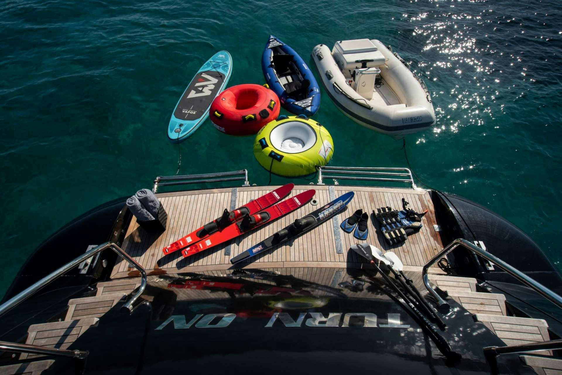 a boat with a paddle and a couple of boats on it aboard TURN ON Yacht for Charter