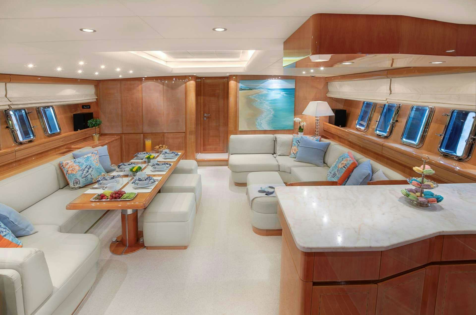 a living room with a large window aboard TURN ON Yacht for Charter