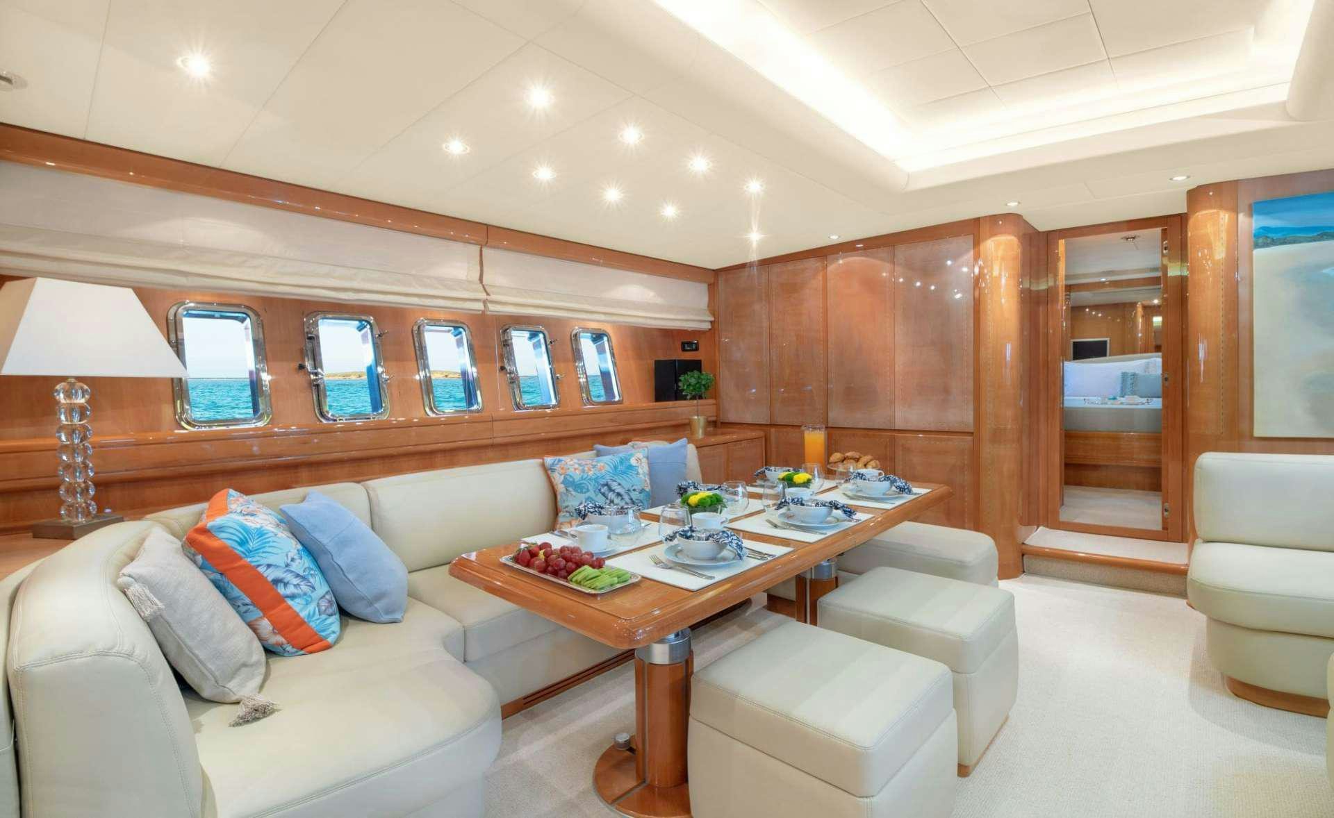 a living room with a couch and a table aboard TURN ON Yacht for Charter