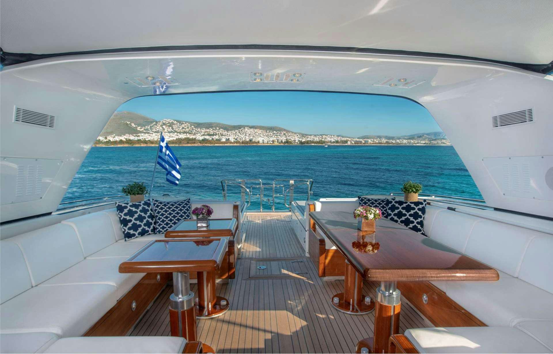 a room with a table chairs and a large body of water aboard TURN ON Yacht for Charter