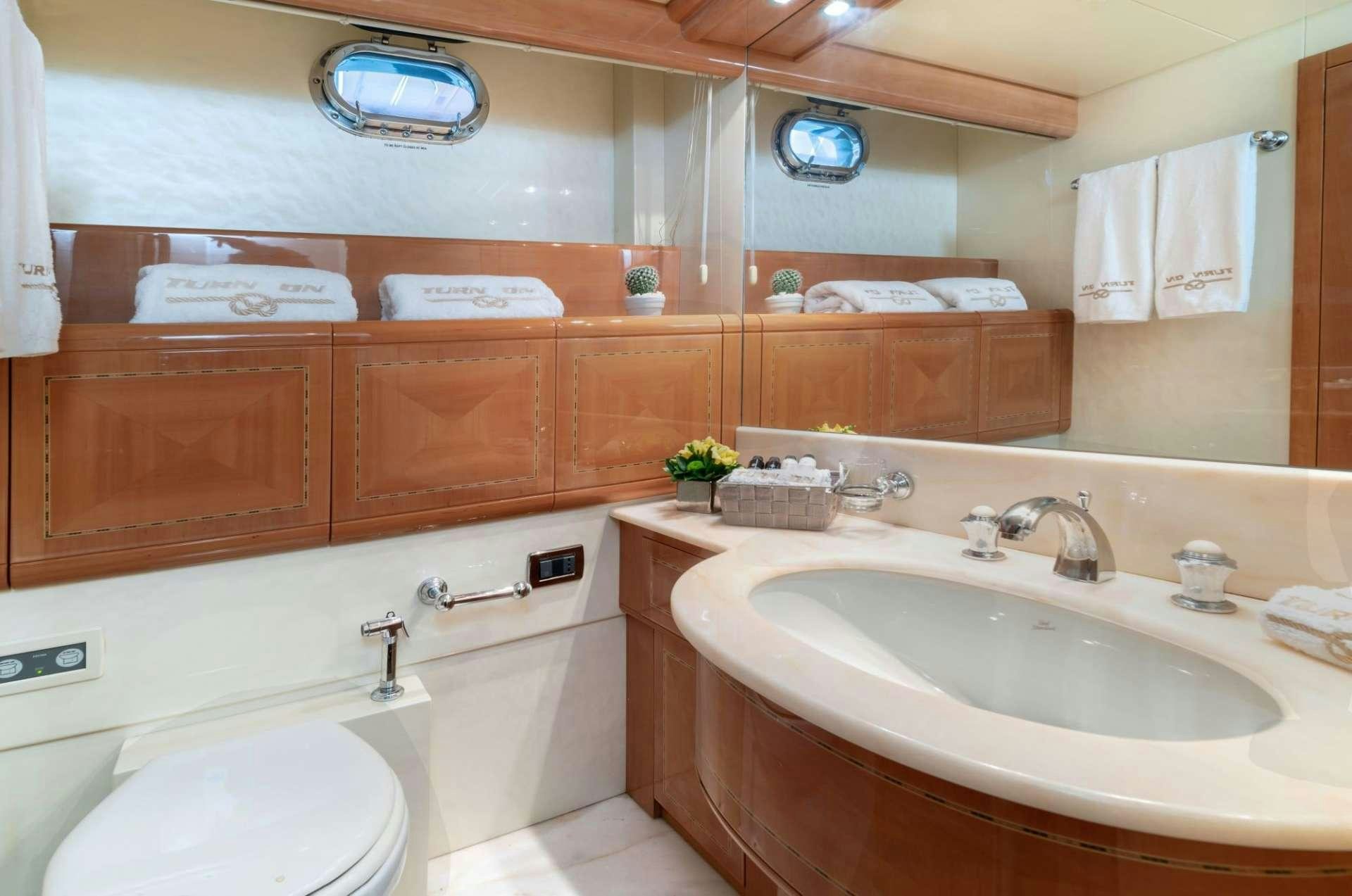 a bathroom with a sink and a toilet aboard TURN ON Yacht for Charter