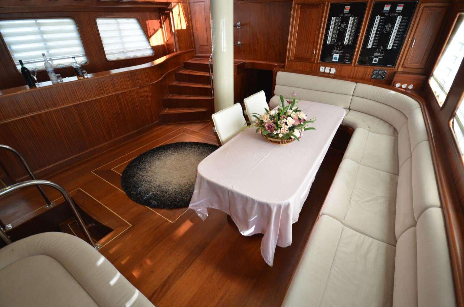 a table and chairs in a room aboard Cagan Yacht for Charter