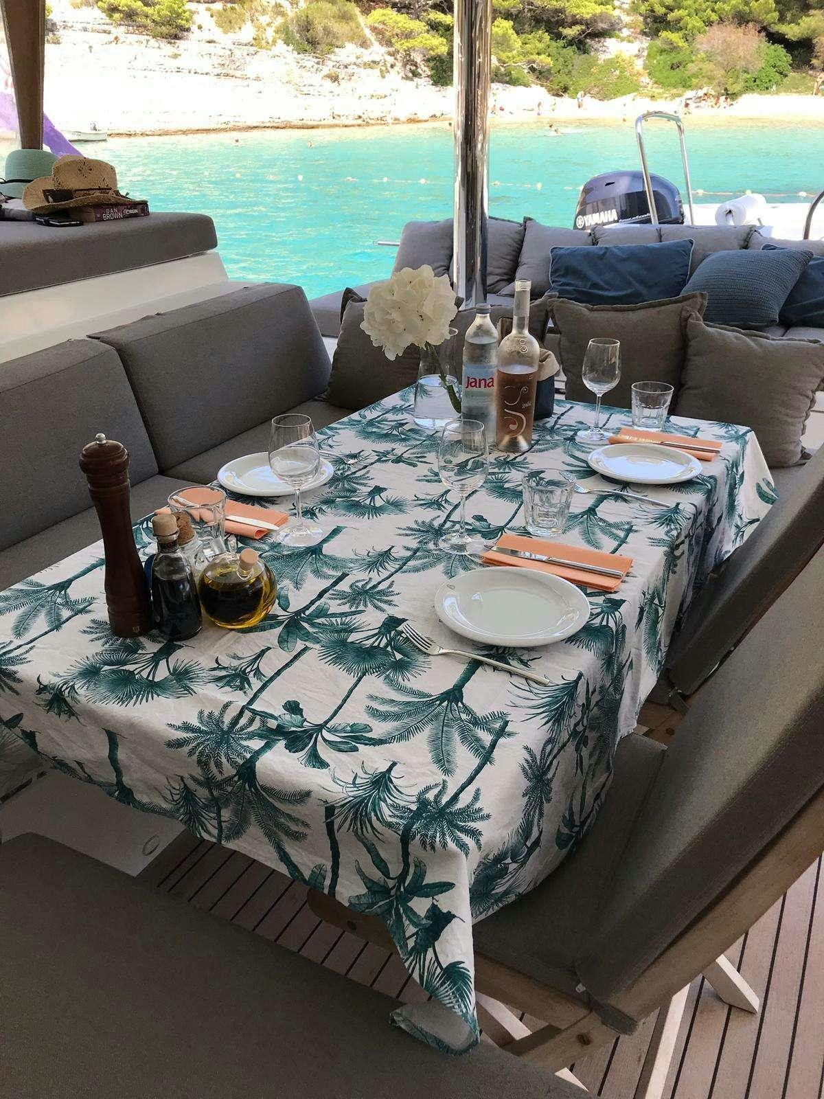 a table with food and drinks on it aboard ARCTIC QUEEN Yacht for Charter