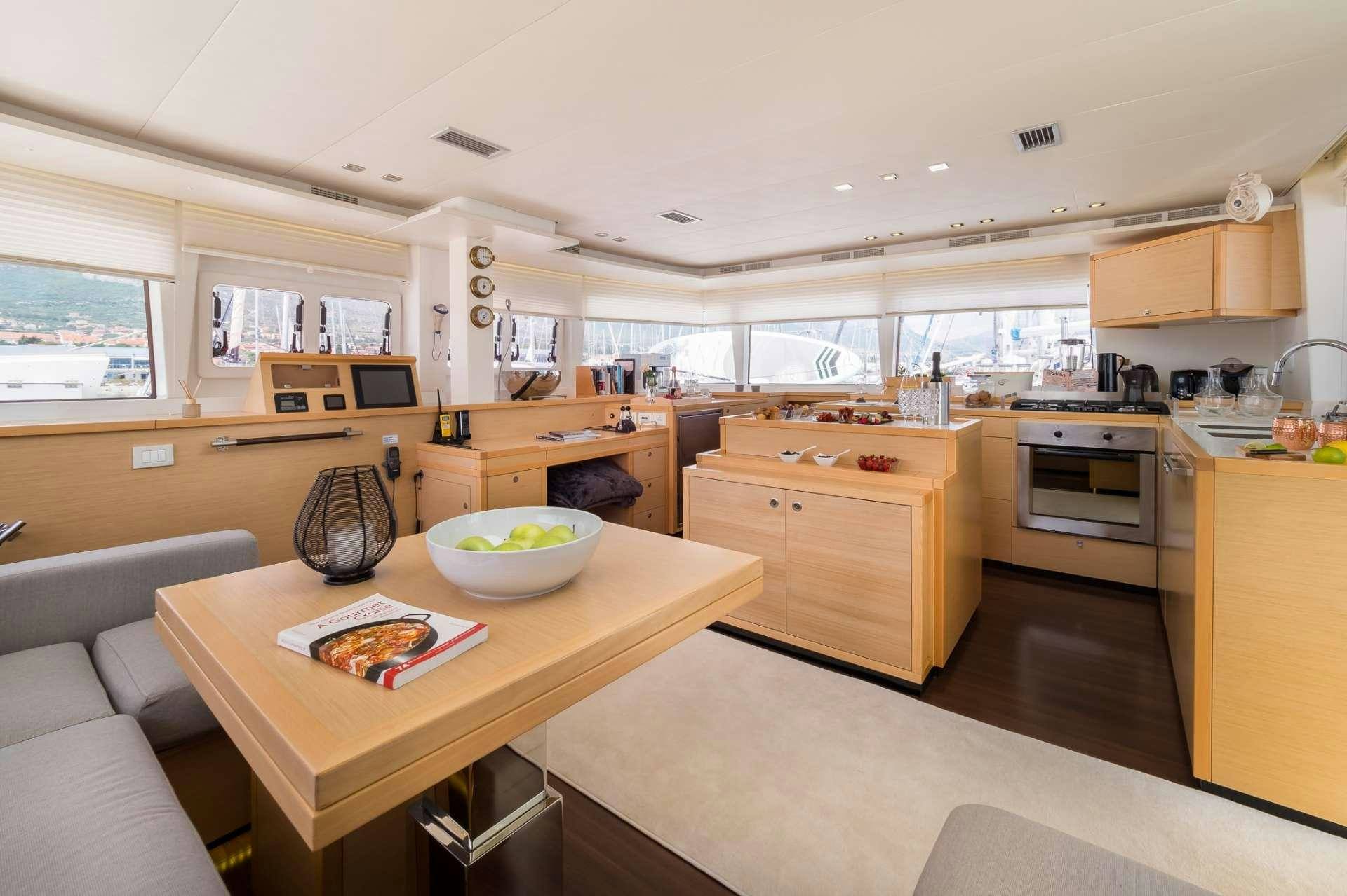a kitchen with a table and a bowl of food aboard ARCTIC QUEEN Yacht for Charter