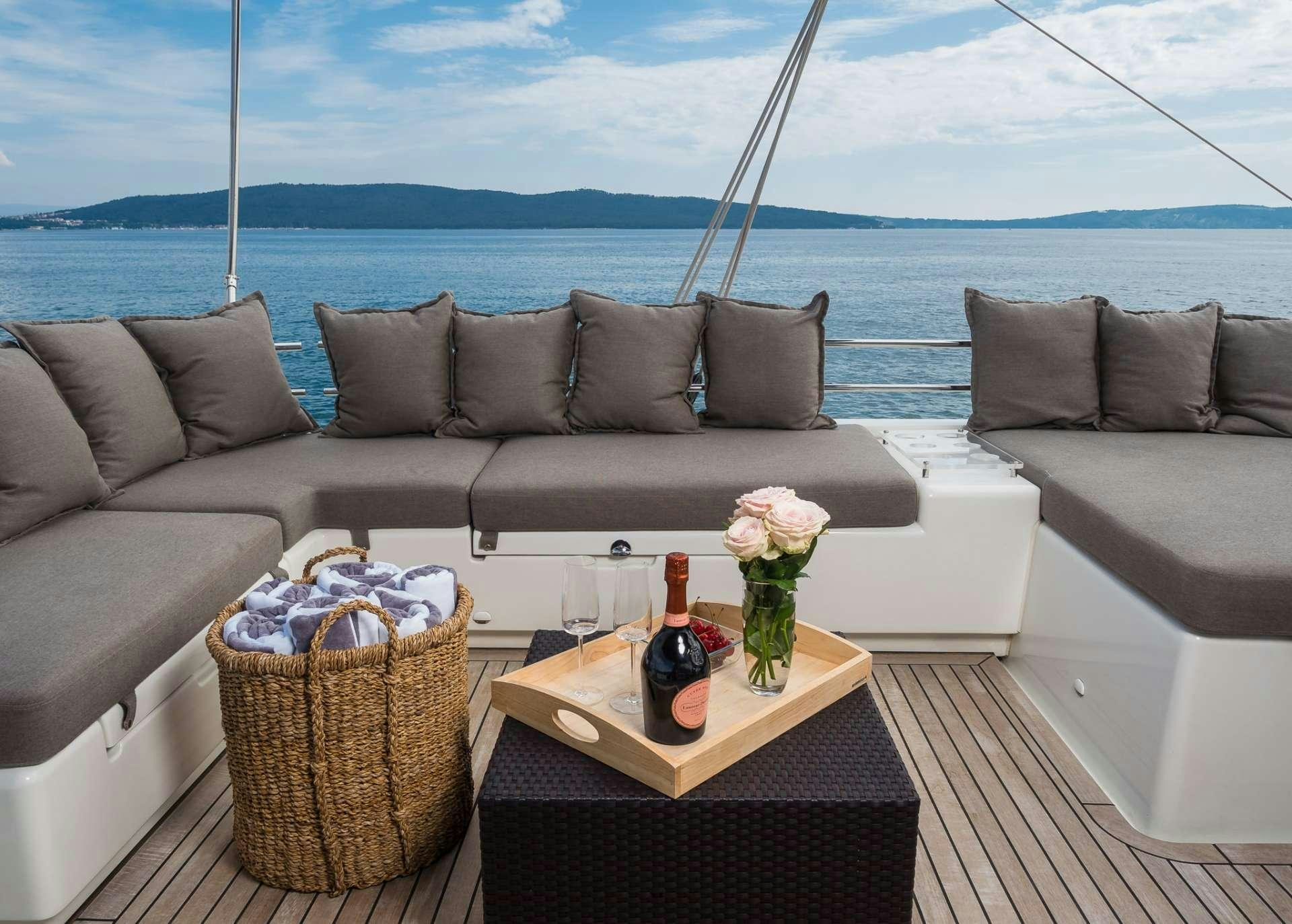 a couch with a table and a vase of flowers on it aboard ARCTIC QUEEN Yacht for Charter