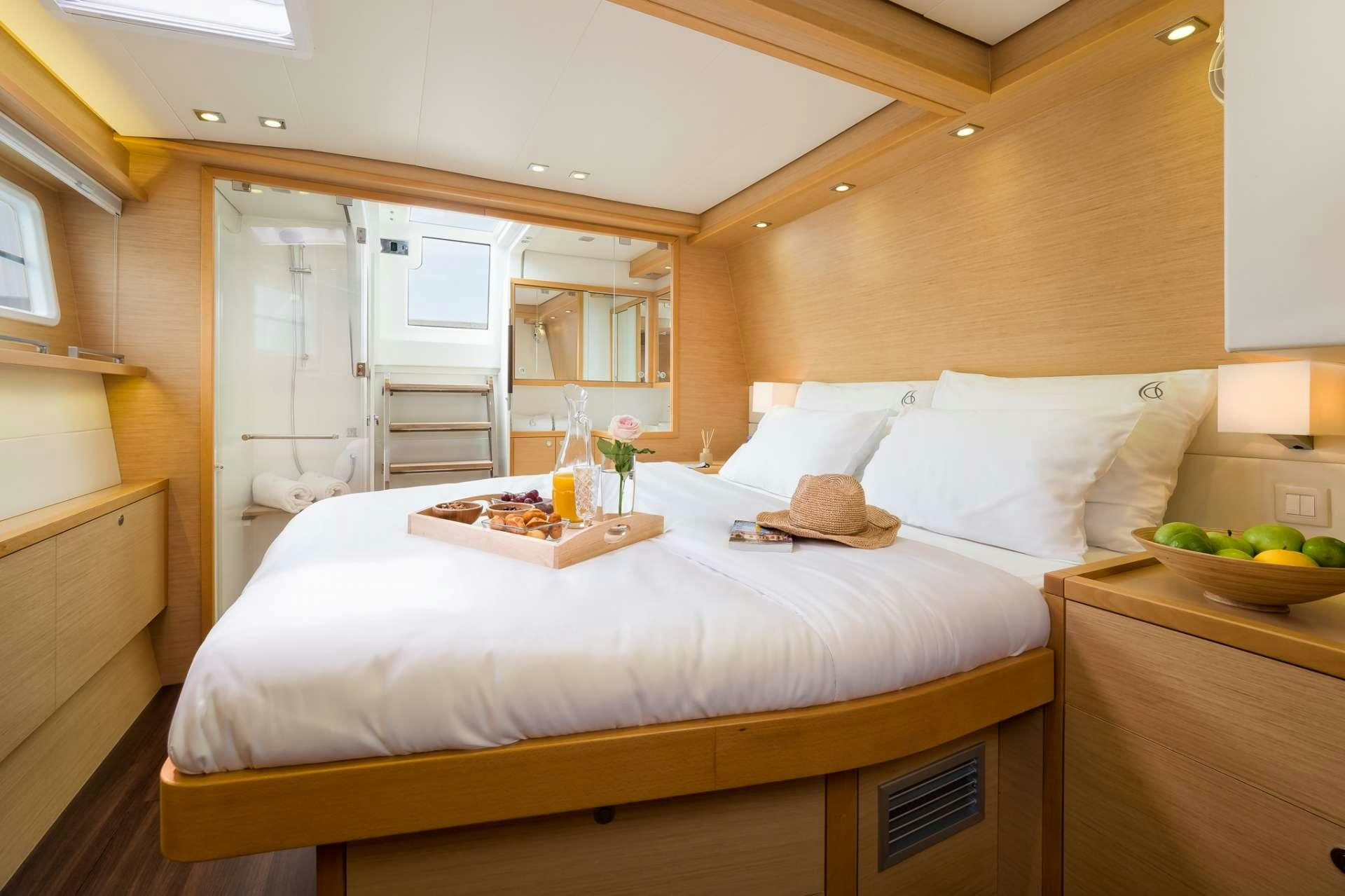 a bed with white sheets aboard ARCTIC QUEEN Yacht for Charter