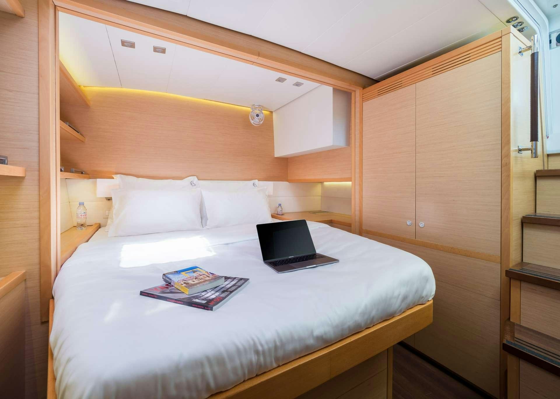 a bed with a laptop on it aboard ARCTIC QUEEN Yacht for Charter