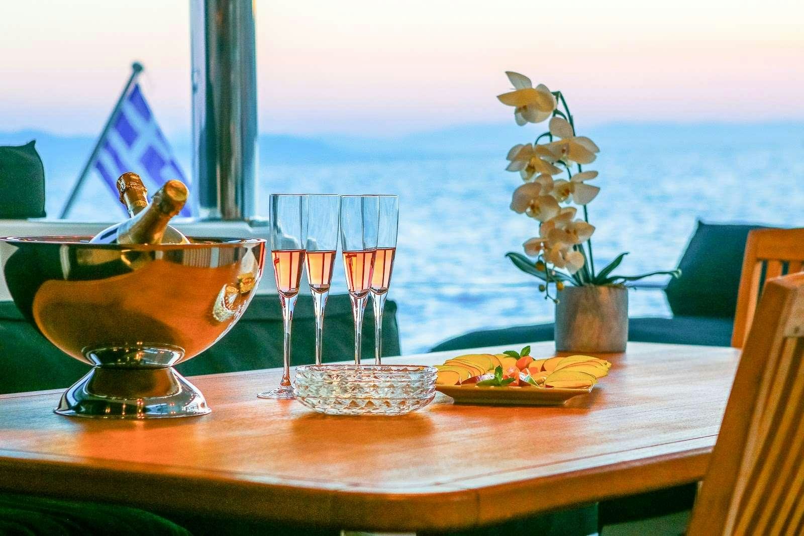 a table with glasses and plates of food on it aboard CARPE DIEM Yacht for Charter