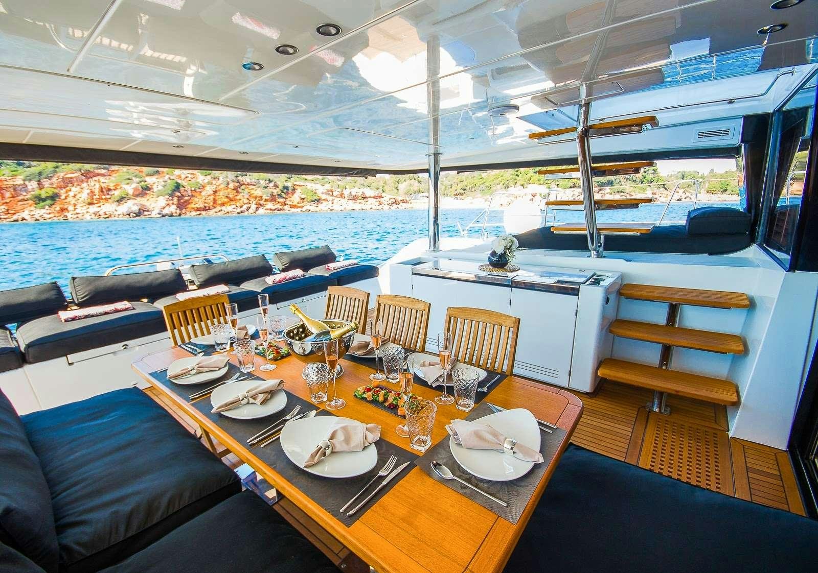 a table with plates and chairs on it aboard CARPE DIEM Yacht for Charter