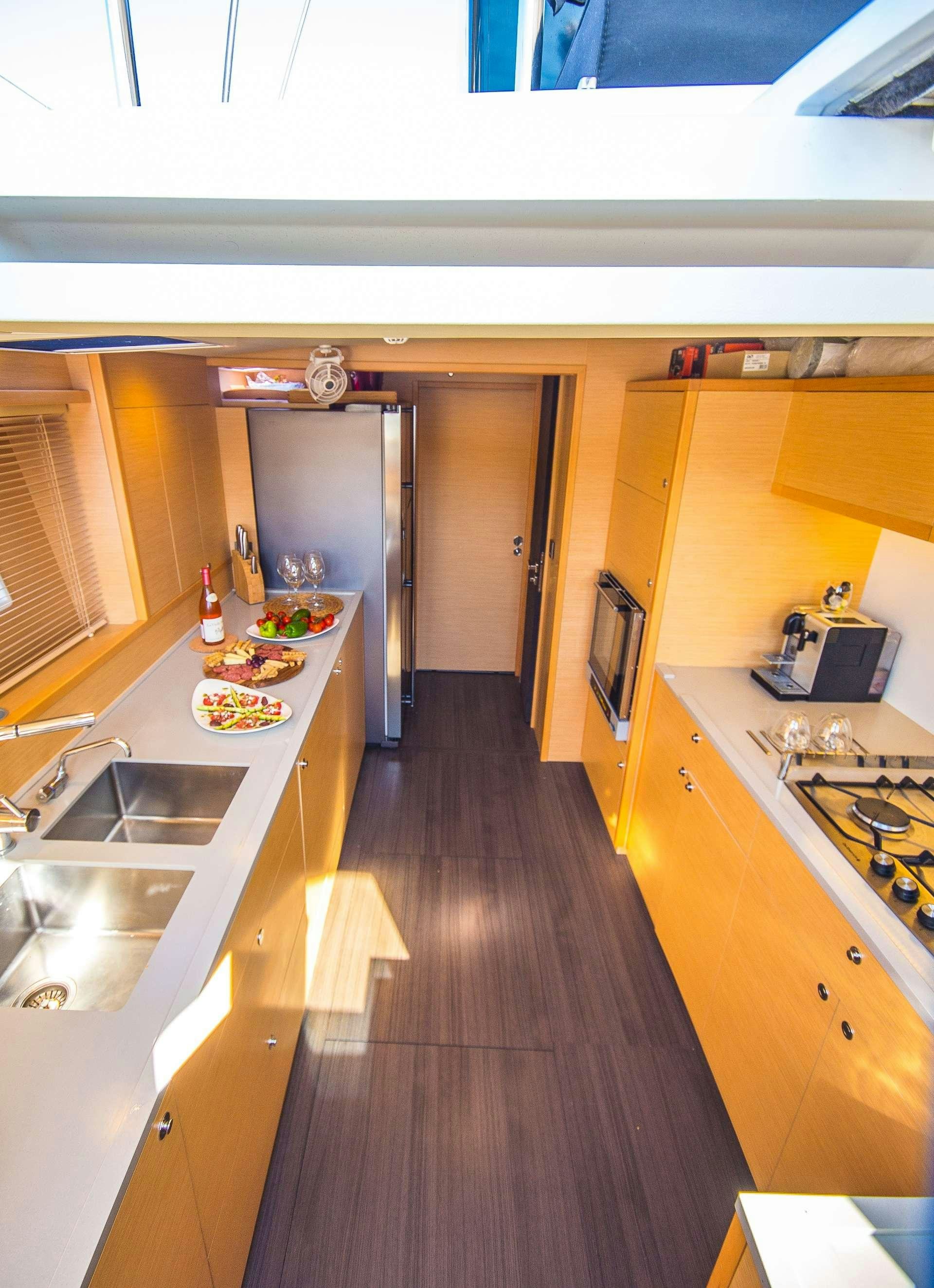a kitchen with yellow cabinets aboard CARPE DIEM Yacht for Charter