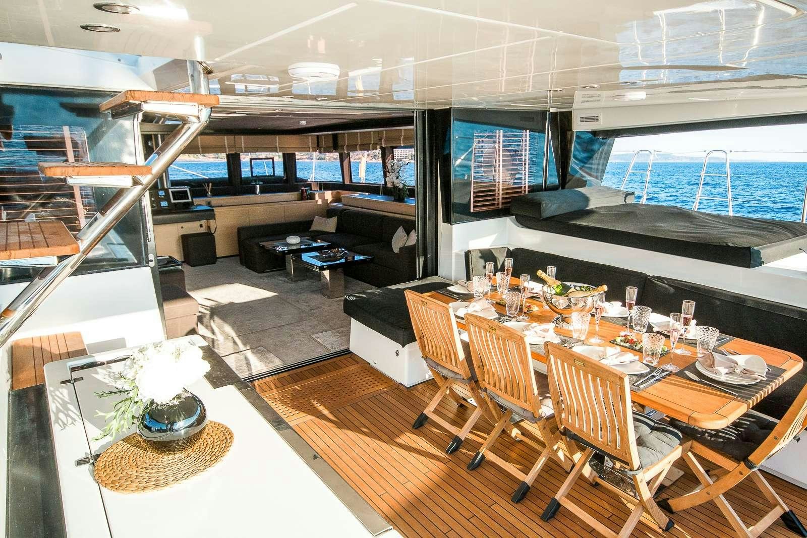a room with a table and chairs aboard CARPE DIEM Yacht for Charter