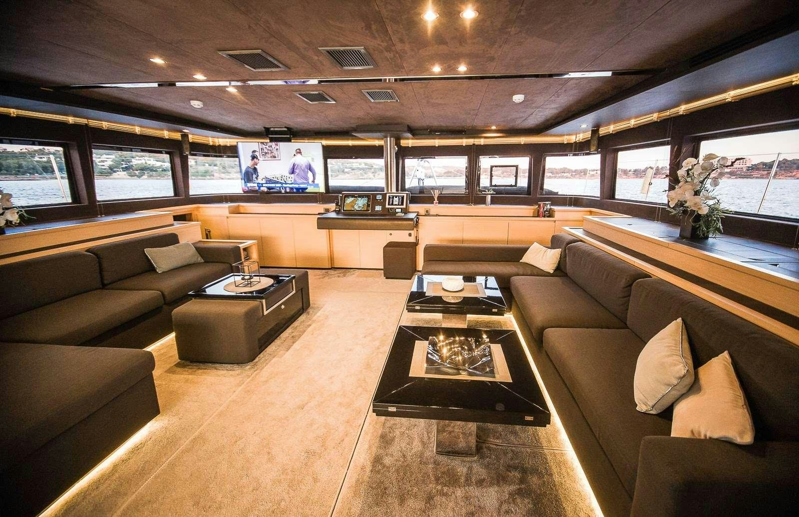 a room with couches and a table aboard CARPE DIEM Yacht for Charter