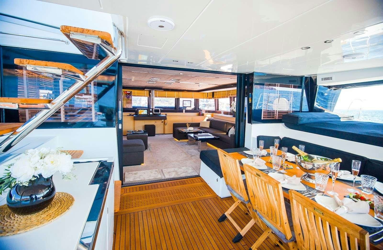 a room with tables and chairs aboard CARPE DIEM Yacht for Charter