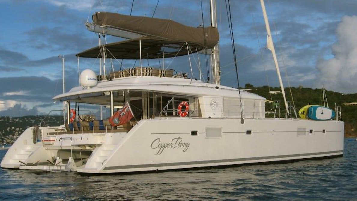 a white boat with a canopy on the front aboard COPPER PENNY Yacht for Charter