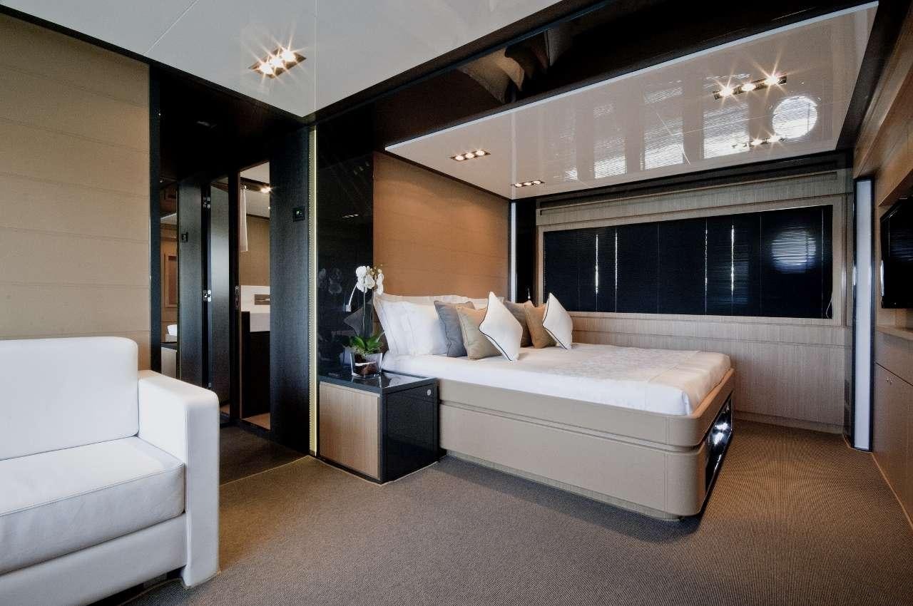 a room with a bed and a couch aboard RHINO A Yacht for Charter