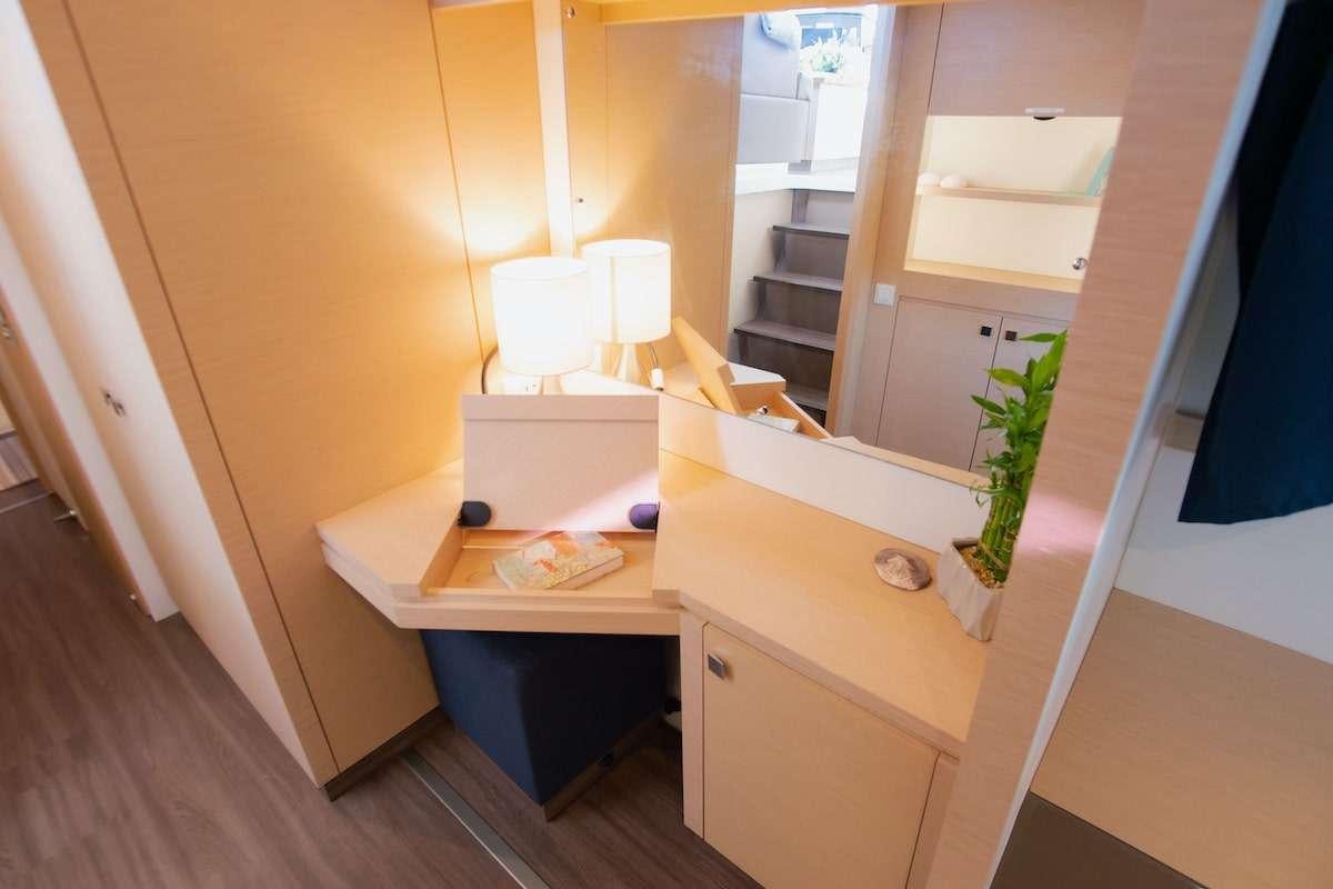 a room with a desk and a shelf with a plant on it aboard EDDIES IN TIME Yacht for Charter