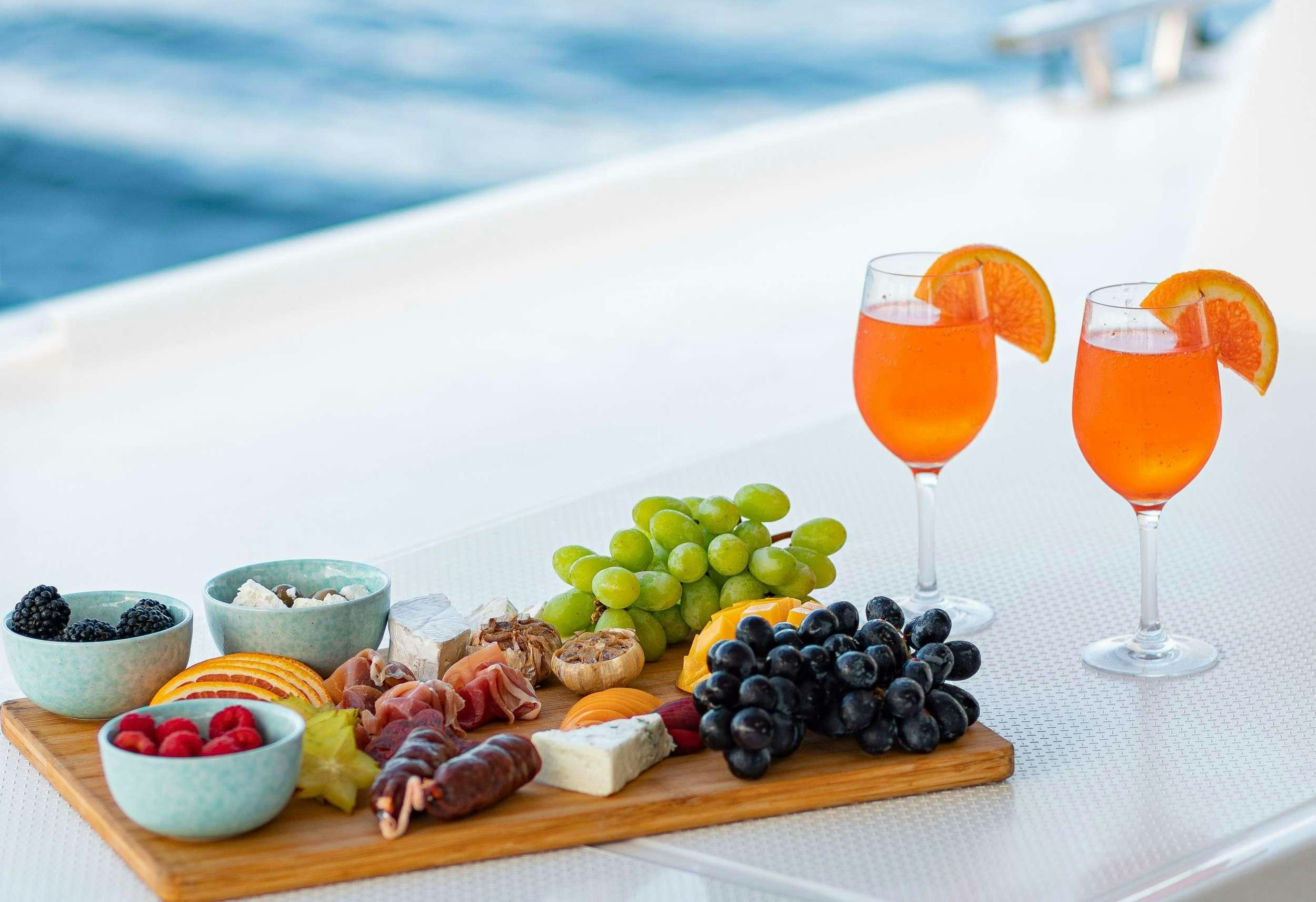a platter of food and a drink aboard EDDIES IN TIME Yacht for Charter