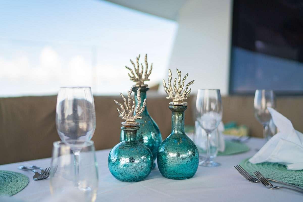 a table with glasses and vases aboard EDDIES IN TIME Yacht for Charter