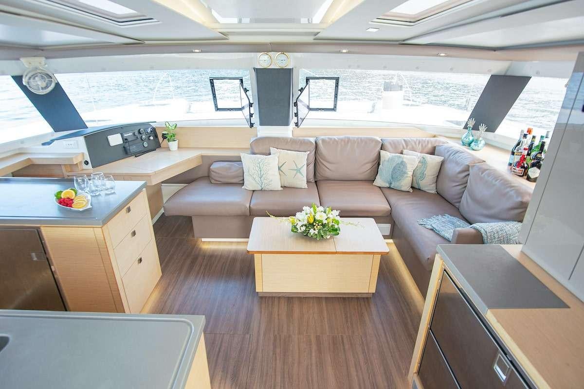 a living room with a couch and a table aboard EDDIES IN TIME Yacht for Charter