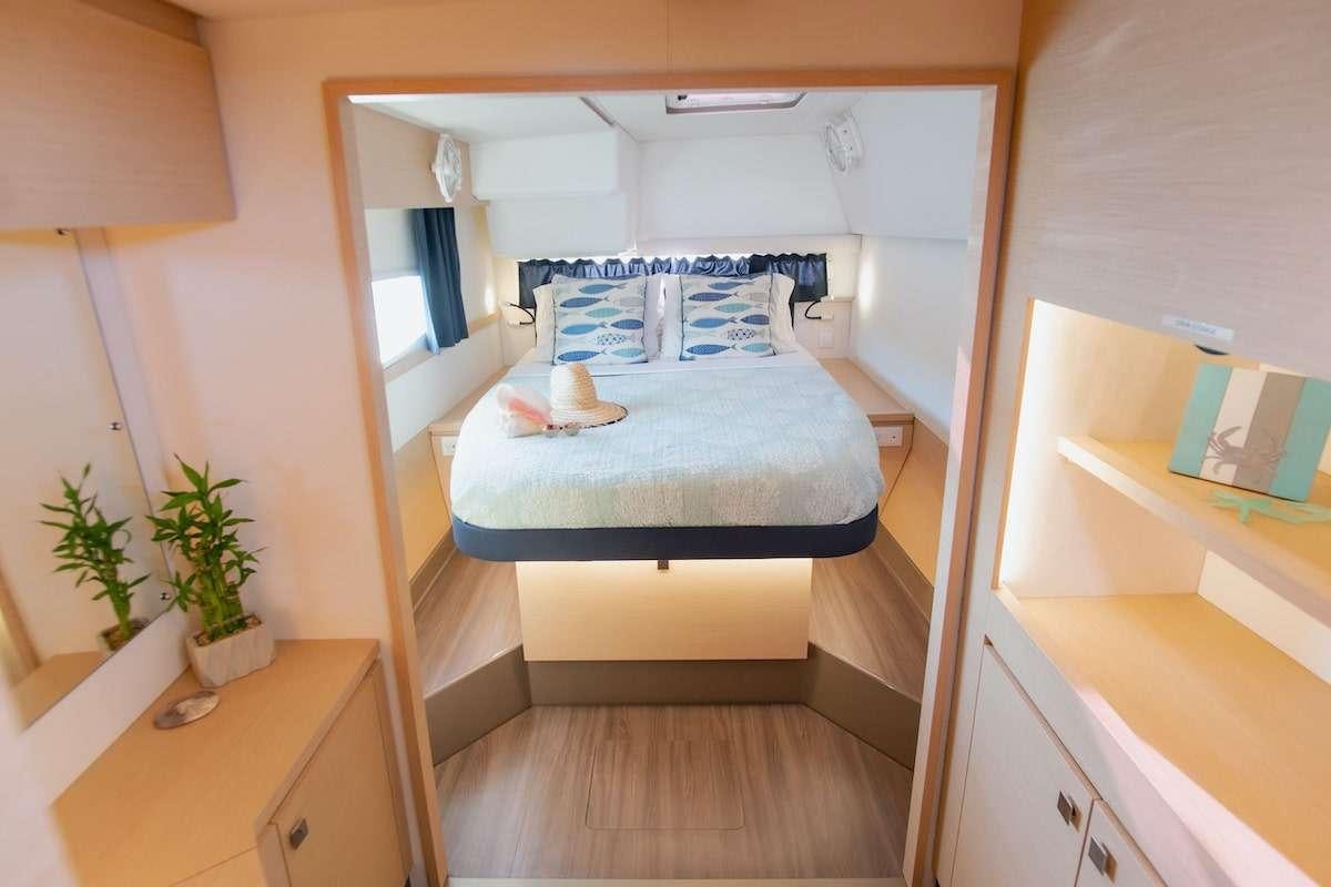 a bedroom with a bed and a desk aboard EDDIES IN TIME Yacht for Charter