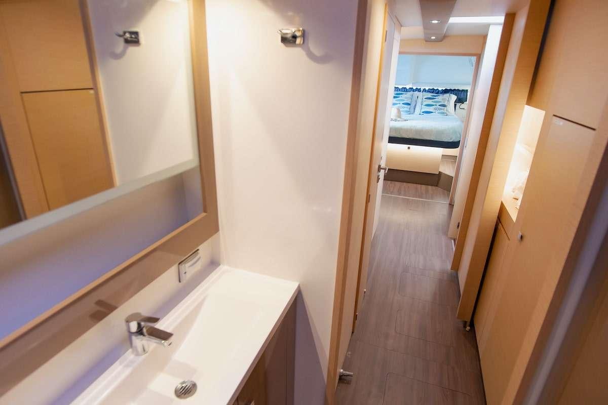 a bathroom with a sink and a bed aboard EDDIES IN TIME Yacht for Charter