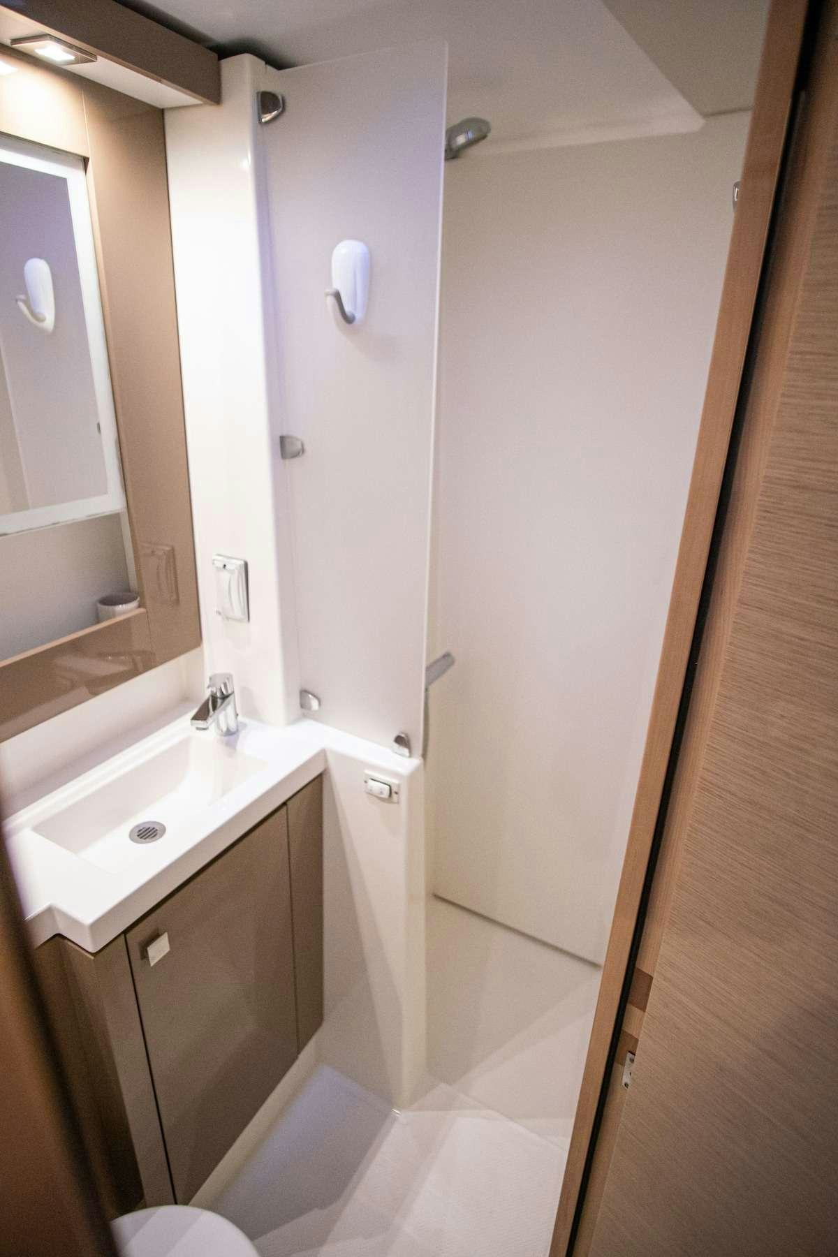 a bathroom with a sink and a mirror aboard EDDIES IN TIME Yacht for Charter