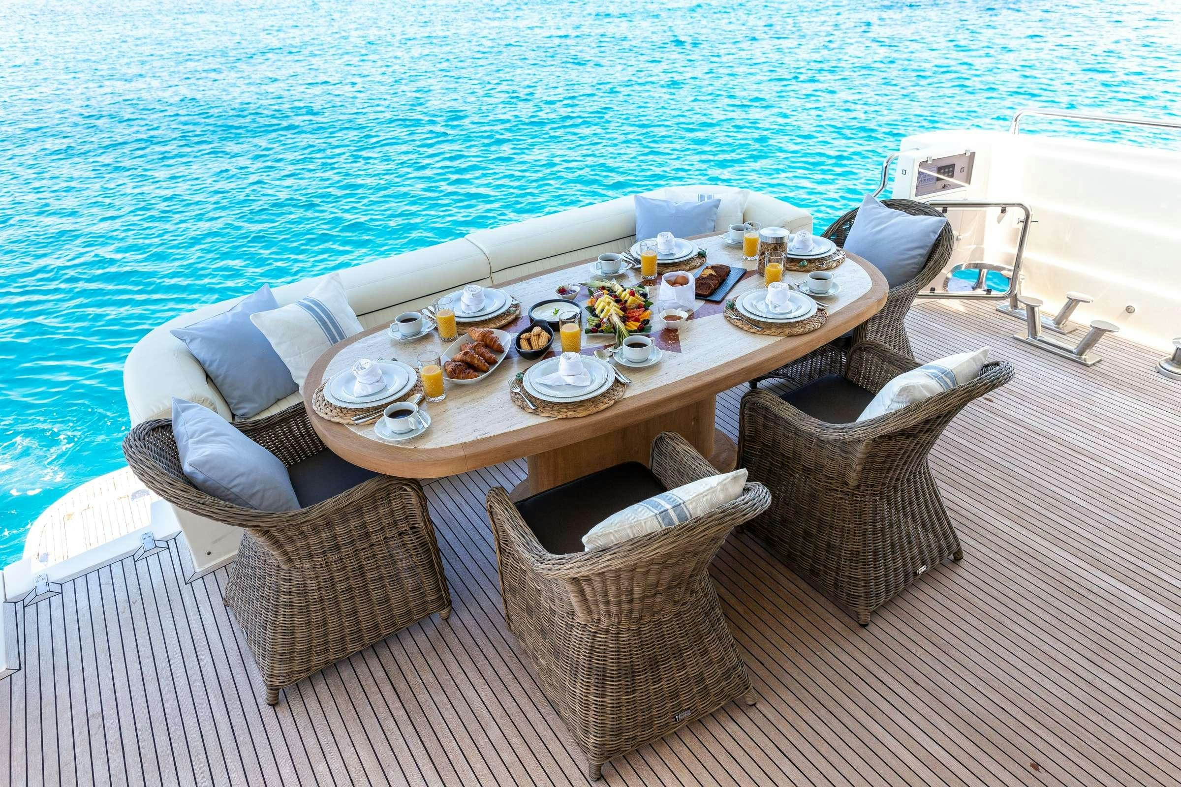 a table set for a meal on a boat aboard PAREAKI Yacht for Charter