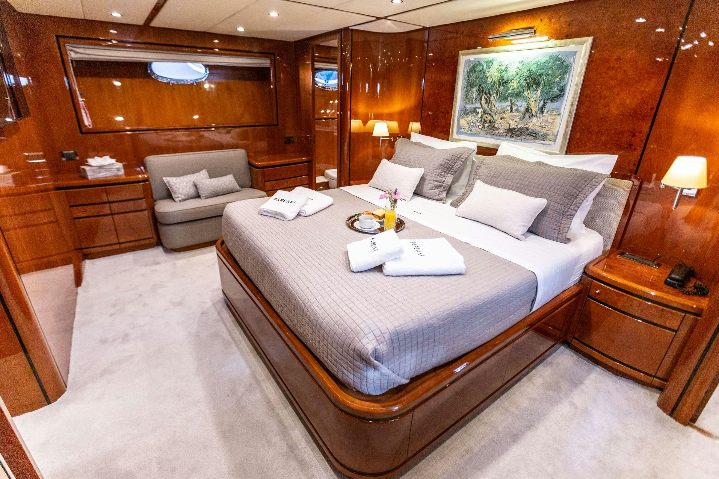 a hotel room with a bed and a chair aboard PAREAKI Yacht for Charter