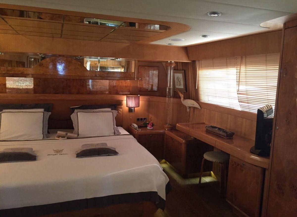 a room with a bed and desk aboard SUHEYLA Yacht for Charter