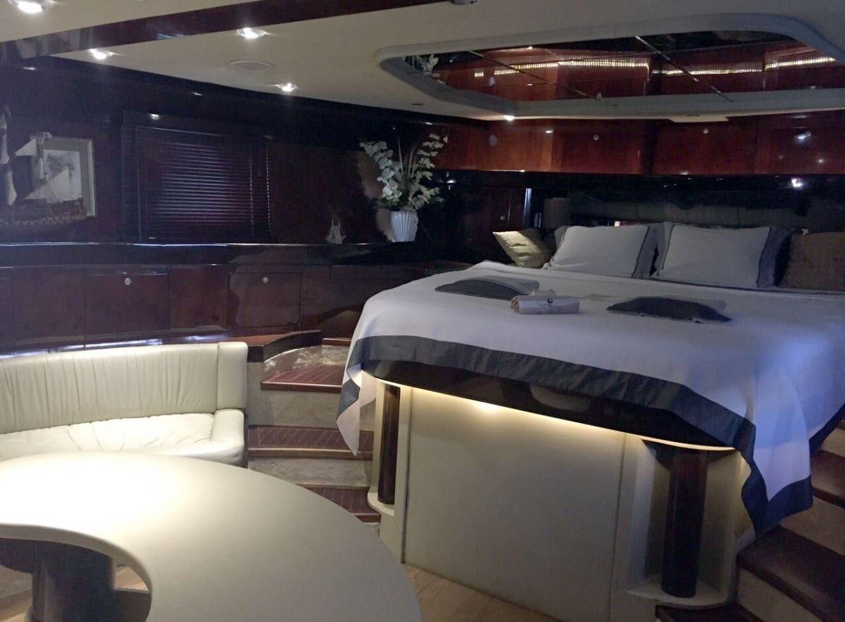 a room with a bed and a couch aboard SUHEYLA Yacht for Charter