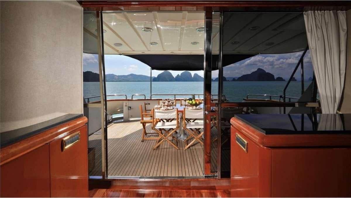 a room with a table and chairs aboard DEMAREST Yacht for Charter