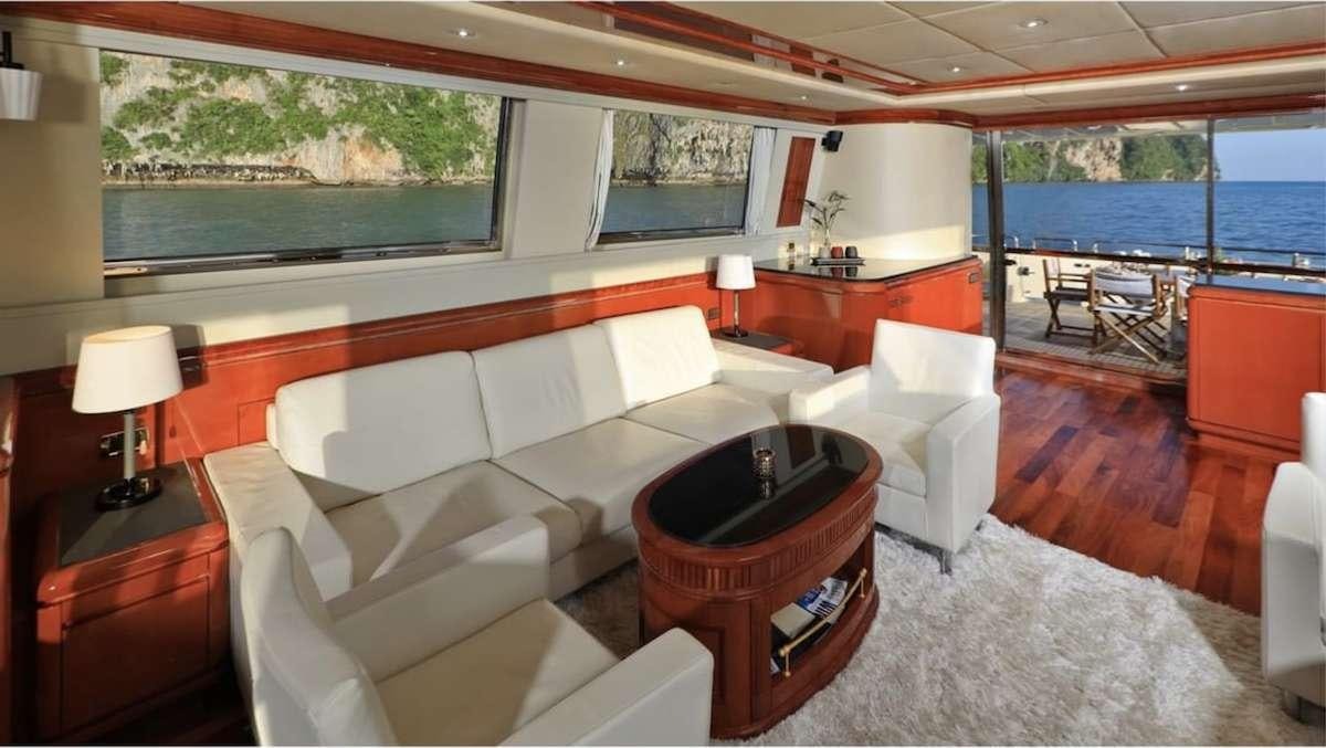 a room with a bed and a table aboard DEMAREST Yacht for Charter