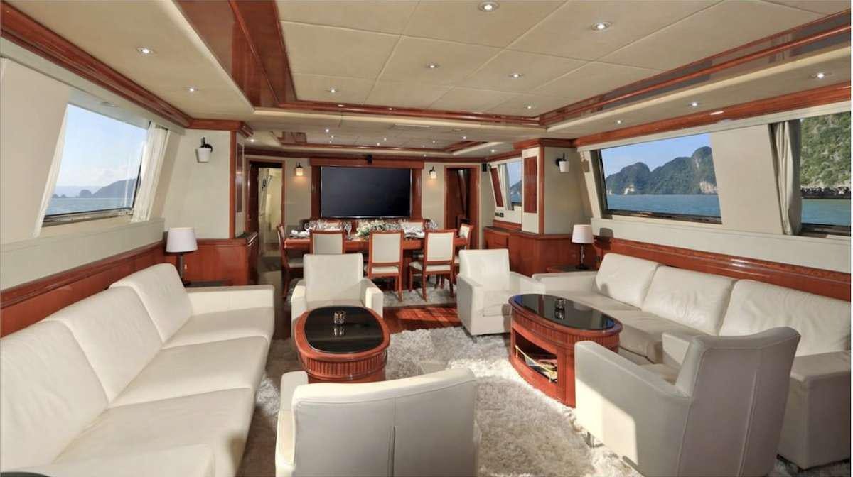 a living room with a large screen aboard DEMAREST Yacht for Charter