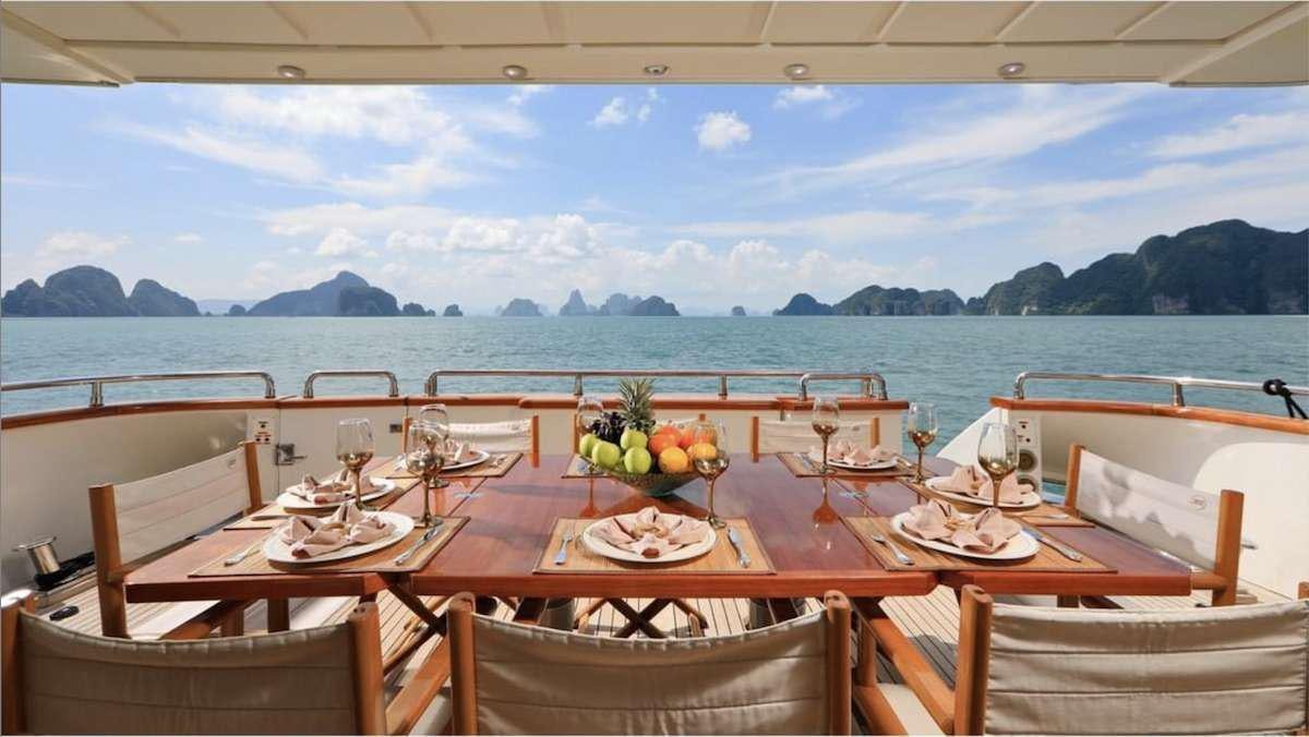 a table set for a meal on a boat aboard DEMAREST Yacht for Charter