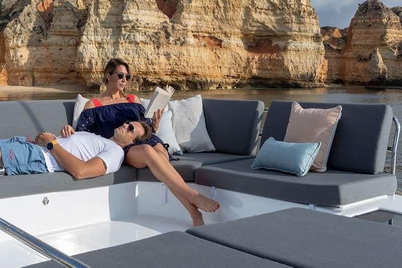 a couple of people sitting on a couch aboard HERO'S JOURNEY Yacht for Charter