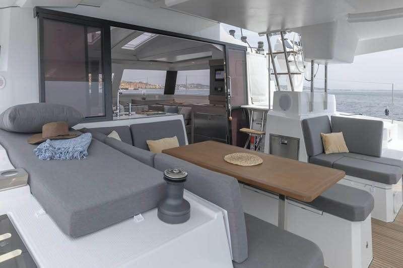 a modern looking living room with a large table and chairs aboard HERO'S JOURNEY Yacht for Charter