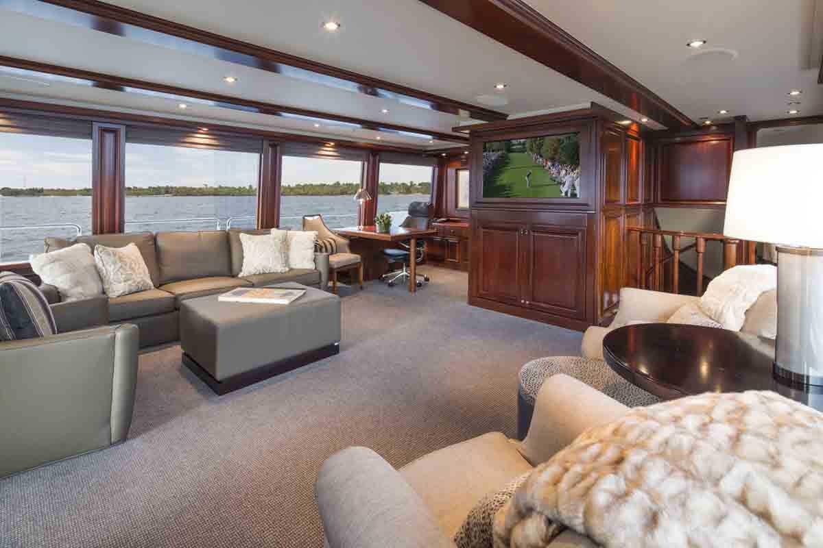 a living room with a large window aboard PLAN A Yacht for Charter