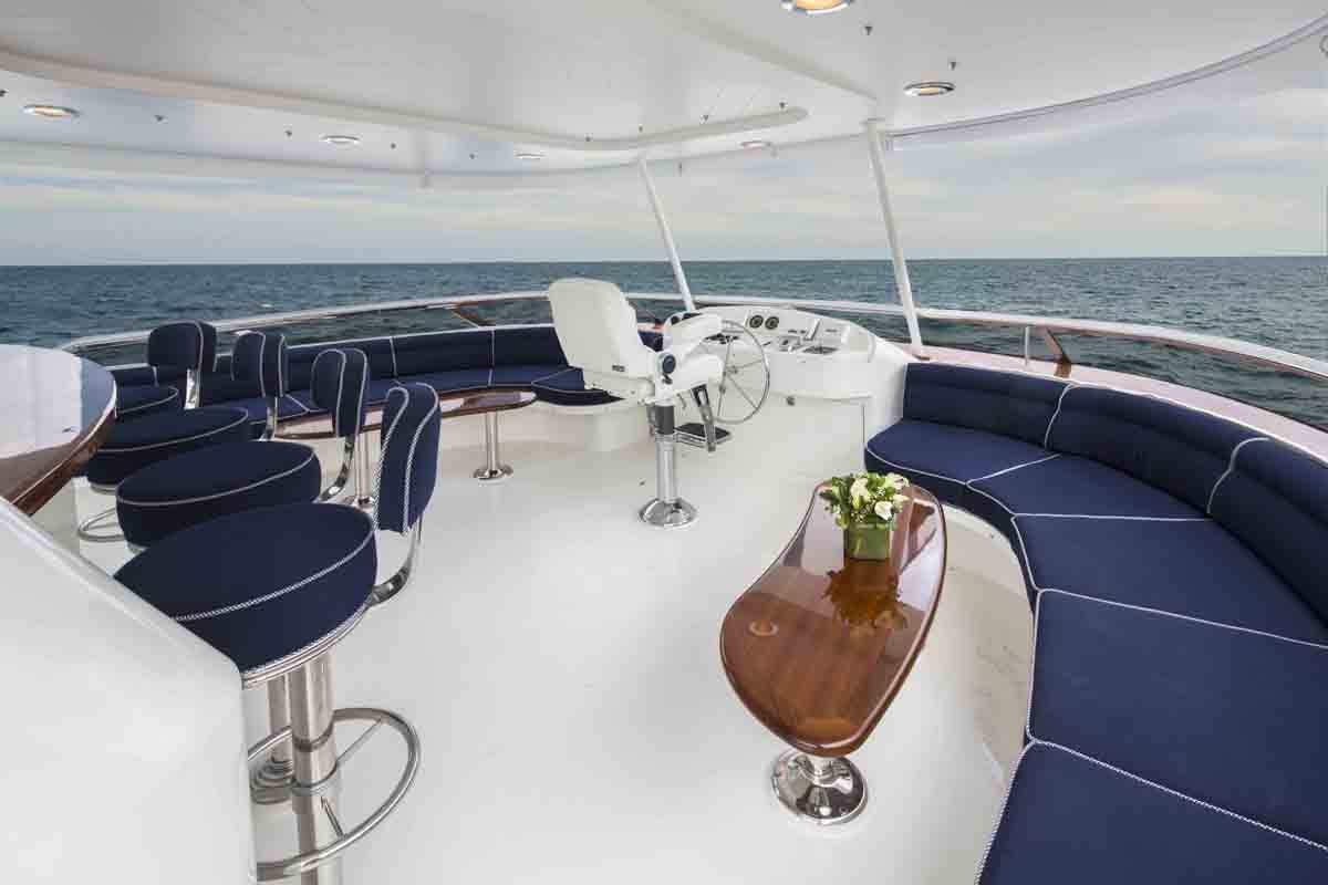 a boat with chairs and a table on it aboard PLAN A Yacht for Charter