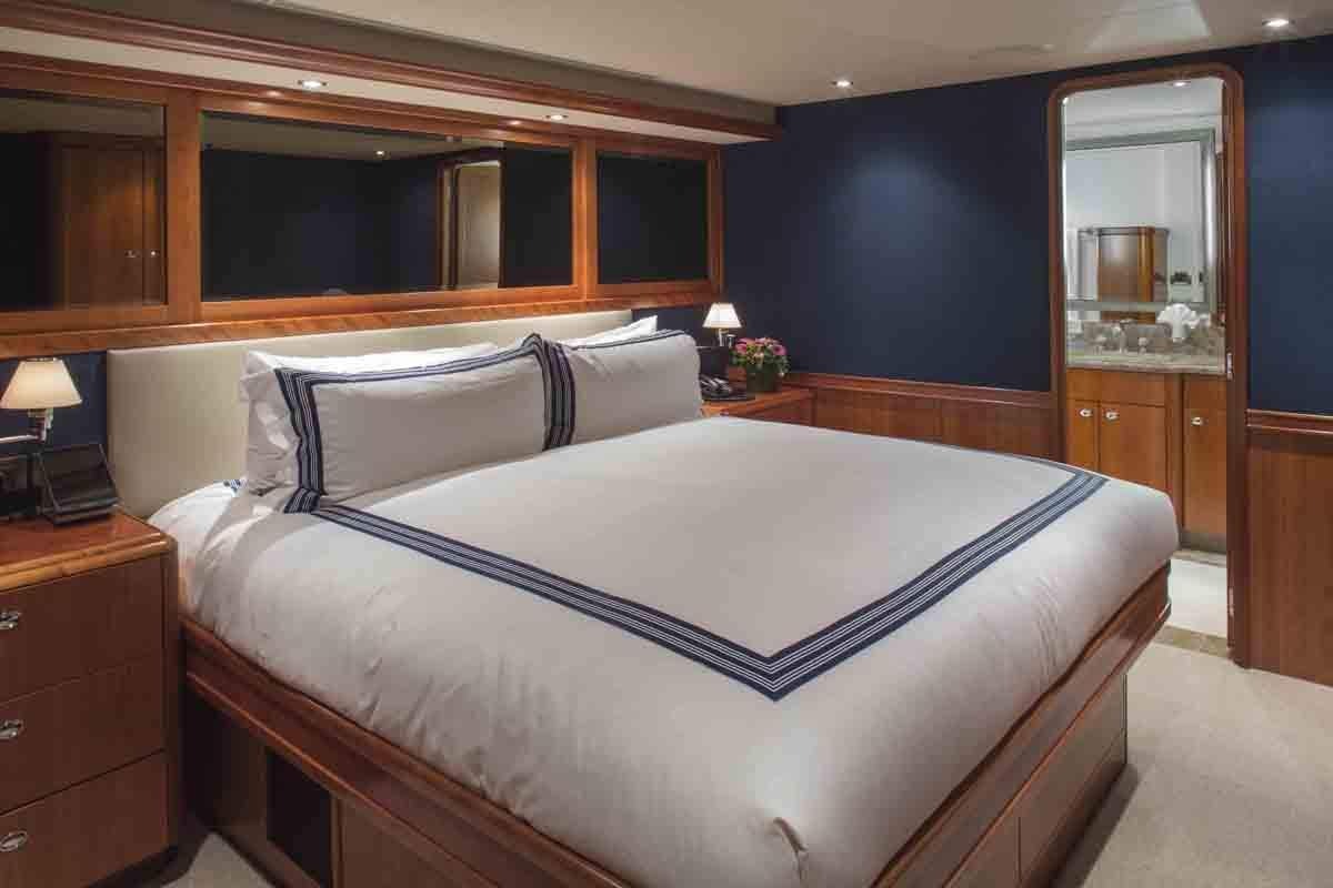 a bed with a white sheet aboard PLAN A Yacht for Charter