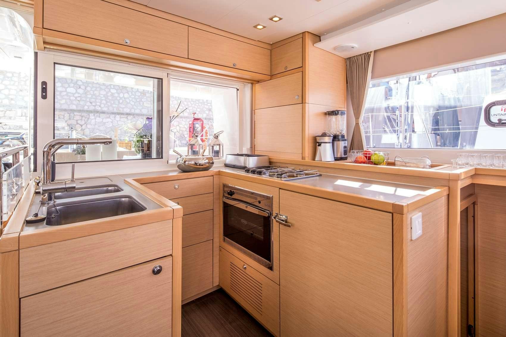 a kitchen with wooden cabinets aboard NEW HORIZONS Yacht for Charter