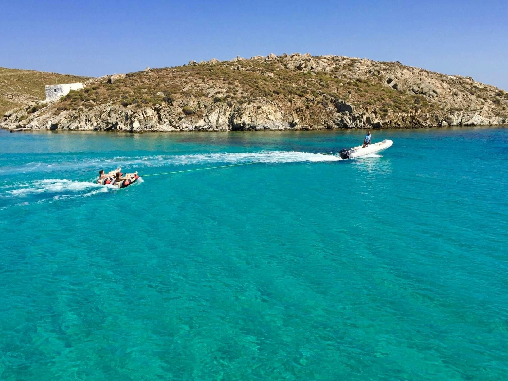 a couple of people on boats in the water aboard NEW HORIZONS Yacht for Charter