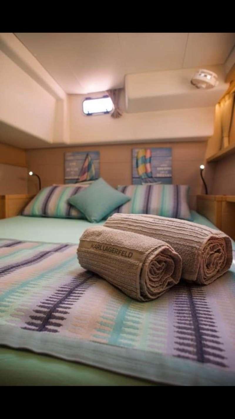 a bed with pillows aboard NEW HORIZONS Yacht for Charter