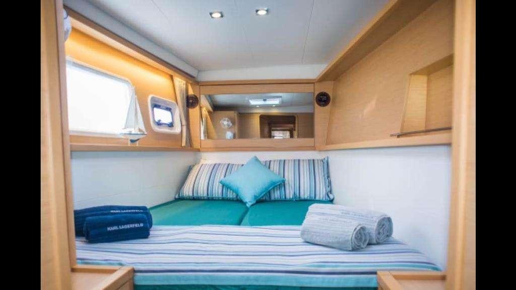 a room with a bed and a window aboard NEW HORIZONS Yacht for Charter