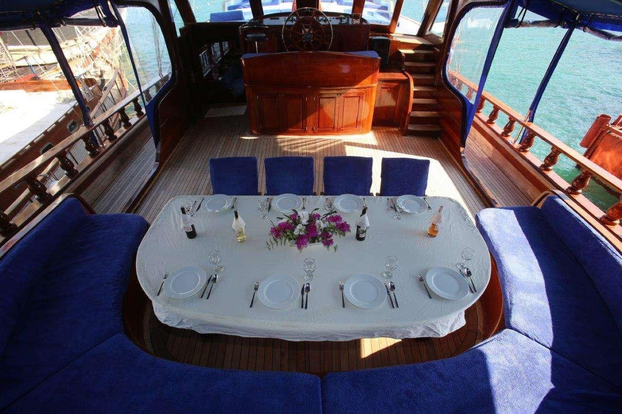 a table set with place settings aboard SEMERCIOGLU IV Yacht for Charter